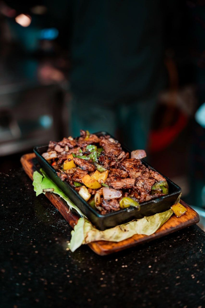 Beef Sizzling — wok-seared on a hot iron plate